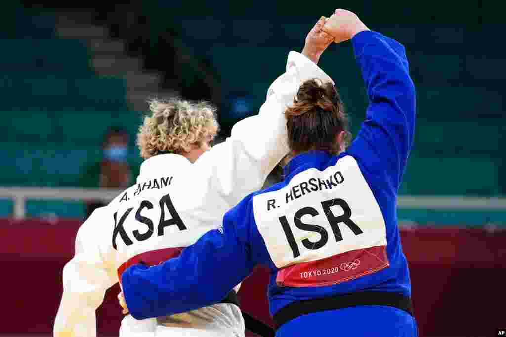 Tahani Alqahtani of Saudi Arabia, left, and Raz Hershko of Israel react after competing in their women&#39;s +78kg elimination round judo match at the 2020 Summer Olympics in Tokyo, Japan. 