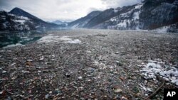 Plastic bottles and waste float at the Potpecko accumulation lake near Priboj, in southwest Serbia, Jan. 22, 2021, as Serbia and other Balkan nations are virtually drowning in communal waste after decades of neglect and lack of efficient waste-management 