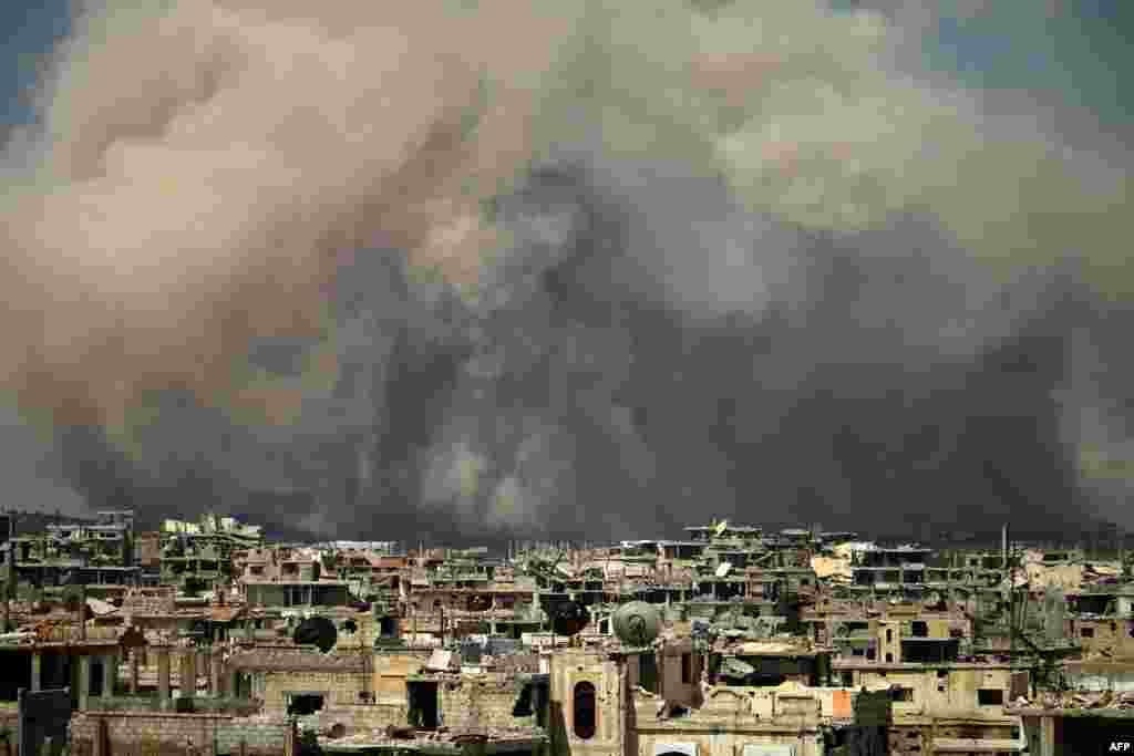 Smoke billows following a reported air strike on a rebel-held area in the southern Syrian city of Daraa.