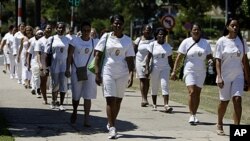 Members of dissident group Ladies in White take part in their weekly march in front of Santa Rita church in Havana, Cuba, March 18, 2012.