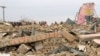 FILE - A Pakistani student stands near remains of a girls school destroyed by alleged militants in Dera Ismail Khan, Pakistan, Feb 3, 2012. Bombing of girls schools is a usual practice of militants fighting against government forces in Pakistan. 