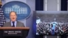 Press Secretary Sean Spicer delivers a statement while television screen show a picture of U.S. President Donald Trump's inauguration at the press briefing room of the White House in Washington, Jan. 21, 2017. 