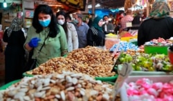 People shop in preparation for the Muslim fasting month of Ramadan, in Baghdad, Iraq, April 21, 2020.