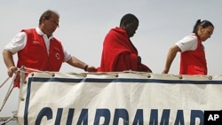 A would-be immigrant arrives with members of the Red Cross after being rescued from the sea at the port of Motril, Spain, May 6, 2011.