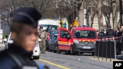 French police officers take position after letter bomb exploded at the French office of the International Monetary Fund, lightly injuring one person, March 16, 2017. 