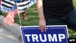 A supporter of US President Donald Trump holds a sign to show support before the vice presidential debate outside Kingsbury Hall at the University of Utah on Oct. 7, 2020, in Salt Lake City, Utah.