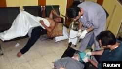 People, affected by what activists say is nerve gas, are treated at a hospital in the Duma neighborhood of Damascus August 21, 2013. 