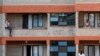 People spend time on their balconies talking to each other at a government-designated quarantine facility in Nairobi, April 6, 2020.