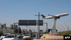 The model of an airplane decorates the center of a roundabout near Irbil's international airport in the capital of Iraq's autonomous northern Kurdish region, April 15, 2021. 