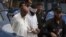 Police escort blindfolded Muslim cleric Khalid Jadoon on suspicion of framing Christian girl Rimsha Masih who was arrested under the country's controversial anti-blasphemy, September 2, 2012.
