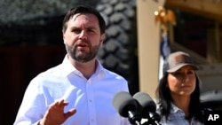 Vice President JD Vance speaks to reporters during a visit to the US border with Mexico, March 5, 2025, in Eagle Pass, Texas, as Director of National Intelligence Tulsi Gabbard listens.