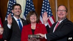 FILE - In this Jan. 3, 2017, file photo, then-House Speaker Paul Ryan administers the House oath of office to Rep. Bill Flores, R-Texas, during a mock swearing in ceremony on Capitol Hill in Washington. 