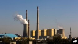 FILE - Smoke billows from a coal-fired power plant in Beijing, China, Nov. 13, 2014.