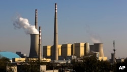 FILE - Smoke billows from a coal-fired power plant in Beijing, China, Nov. 13, 2014.