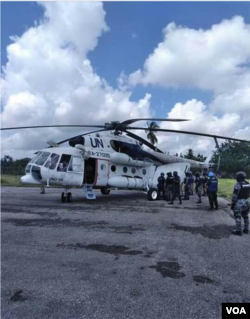 Arnel Joseph dressed and on a stretcher. UN helicopter prepares to transfer him to Port au Prince.