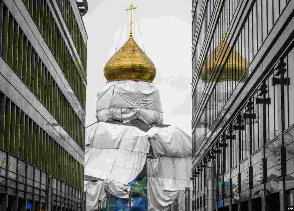 The church of Saint Nicholas on Tverskaya Zastava is seen covered with plastic sheets as it undergoes restoration in Moscow.