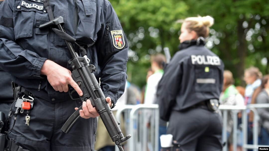 FILE - Police patrol near the Brandenburg Gate in Berlin, Germany, May 24, 2017.