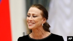 FILE - Russian ballet dancer Maya Plisetskaya smiles at a presentation ceremony of state awards in the Kremlin in Moscow, Russia, Oct. 31, 2011.