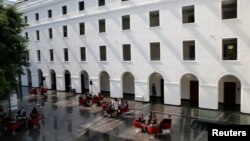 FILE - People are pictured in the headquarters of the World Trade Organization in Geneva, Switzerland, April 12, 2017. 