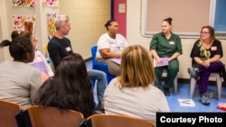 Teaching artists from Carnegie Hall’s Weill Music Institute discuss the process of writing lullabies with women as part of Carnegie Hall’s Lullaby Project, Rikers Island, New York, Feb. 18, 2015. (Chris Lee)