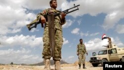 FILE - Army soldiers man a checkpoint in al-Mahfad, in the southern Yemeni province of Abyan, May 23, 2014. An attack by an unmanned aircraft on a car in southern Yemen overnight killed four suspected al Qaida militants.