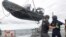 FILE: Members of Sea Shepherd, an ocean conservation group, lower an inflatable dinghy from the deck of the Ocean Warrior off the west coast of South America on July 17, 2021. Activists are seeking restrictions on fishing as part of a first-ever international High Seas Treaty.