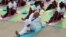 India's Prime Minister Narendra Modi participates in a yoga session to mark International Day of Yoga, in New Delhi, India, June 21, 2015. Modi led tens of thousands of people in the yoga session in the centre of the capital on Sunday to showcase the country's signature cultural export, which has prompted criticism of fomenting social divisions at home. 
