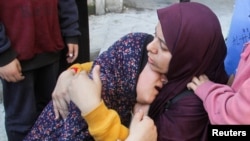 Palestinians react at the site of an Israeli strike on a school sheltering displaced people in Gaza City on Dec. 14, 2024.