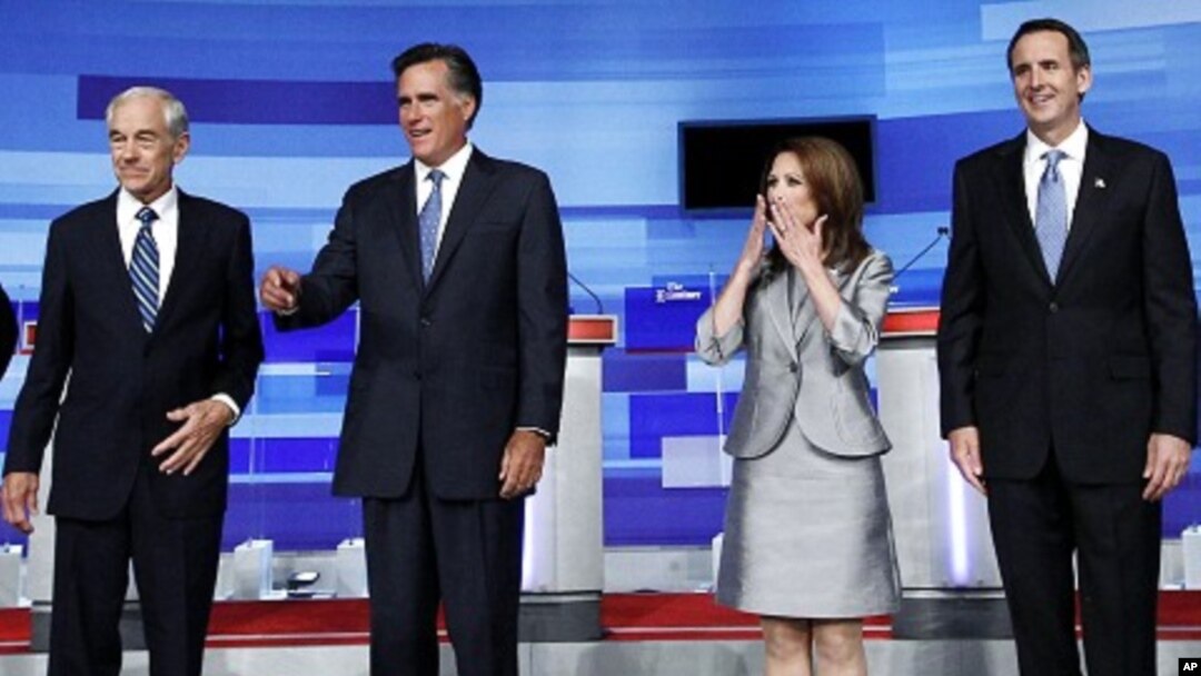 U.S. Republican presidential candidates Ron Paul (L), Mitt Romney (2nd L), Michele Bachmann and Tim Pawlenty (R) gather before the start of their debate in Ames, Iowa August 11, 2011.
