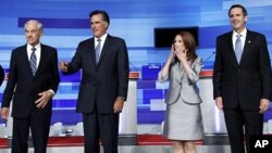 U.S. Republican presidential candidates Ron Paul (L), Mitt Romney (2nd L), Michele Bachmann and Tim Pawlenty (R) gather before the start of their debate in Ames, Iowa August 11, 2011