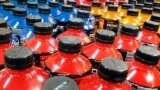 FILE - Sodas and energy drinks line the shelves in a grocery store in Springfield, Illinois, May 18, 2016. The World Health Organization recommends countries use tax policy to increase the price of sugary drinks as a way to fight obesity and diabetes.