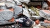 A child’s shoe is seen among the rubble after an explosion at the Shin Kong Mitsukoshi department store in Taichung, Taiwan, on Feb. 13, 2025.