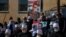 Druse supporters of Syrian President Bashar Assad display display pictures of him during a rally close to the Syrian border demanding the return of the Golan Heights, captured by Israel in 1967, in Majdal Shams, Golan Heights, Feb. 14, 2021.