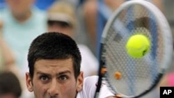 Serbia's Novak Djokovic hits a backhand return against Tomas Berdych, from the Czech Republic, during a semifinal match at the Western & Southern Open tennis tournament in Mason, Ohio, August 20, 2011