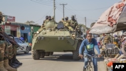 FILE - A Zambian Army armored personnel carrier patrols the Chawama Compound in Lusaka, Aug. 3, 2021, after President Edgar Lungu ordered the army to help police curb political violence in the run-up to the Aug. 12 elections.