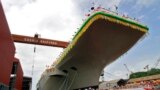 Employees of Cochin Shipyard stand beside India&#39;s Indigenous Aircraft Carrier P-71 &#39;Vikrant&#39; built for the Indian Navy during its launch in the southern Indian city of Kochi, India.