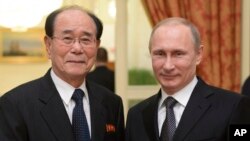 FILE - In this Feb. 7, 2014, photo, Russian President Vladimir Putin, right, shakes hands with president of the Presidium of North Korea's Supreme People's Assembly Kim Yong Nam at the Olympic reception hosted by the Russian President in Sochi, Russia.