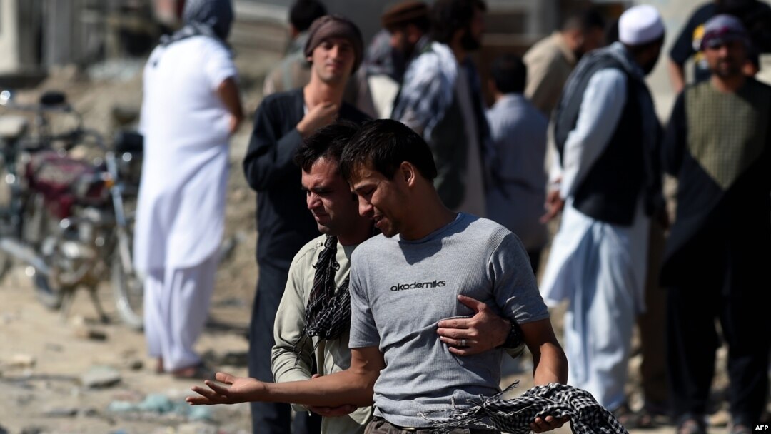 An Afghan man cries as he search for his relatives near Camp Integrity, a base housing US special forces that was attacked by militants, in Kabul, Aug. 8, 2015. 