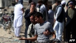 An Afghan man cries as he search for his relatives near Camp Integrity, a base housing US special forces that was attacked by militants, in Kabul, Aug. 8, 2015. 