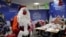 A postal worker dressed as Santa, talks with co-workers as they open envelopes addressed to ‘Pere Noel’ - Father Christmas in French - decorated with love hearts, stickers and glitter, in Libourne, southwest France, Nov. 23, 2020.