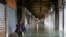 A person walks in the flooded St. Mark's Square during a period of seasonal high water in Venice, Italy, Nov. 12, 2019.