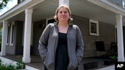 Rebecca Wood stands outside her home in Maynard, Massachusetts, Aug. 30, 2024. Wood noticed she was being charged a "program fee" each time she loaded money onto her daughter's school lunch account. 