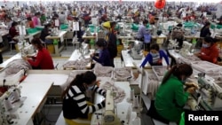 In this file photo taken on Dec. 12, 2018, employees work at a factory supplier of the H&M brand in Kandal province, Cambodia.