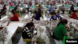 In this file photo taken on Dec. 12, 2018, employees work at a factory supplier of the H&M brand in Kandal province, Cambodia.