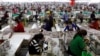 FILE - Employees work at a factory supplier of the H&M brand in Kandal province, Cambodia, Dec. 12, 2018.