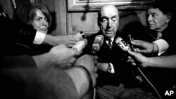 FILE - This Oct. 21, 1971 file photo shows Pablo Neruda, poet and then Chilean ambassador to France, talking with reporters in Paris after being named the 1971 Nobel Prize for Literature. Neruda died in 1973.