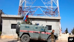 Russian forces armored vehicles patrol the Syrian border in Kobani, Oct. 23, 2019.