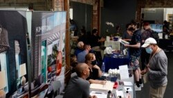 FILE - Prospective employers and job seekers interact during a job fair on Sept. 22, 2021, in the West Hollywood section of Los Angeles.