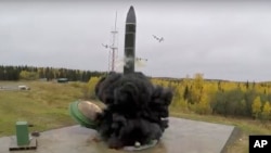 FILE - In this undated photo distributed by Russian Defense Ministry Press Service, an intercontinental ballistic missile lifts off from a silo in Russia. The Russian military said the Avangard hypersonic weapon entered combat duty on Dec. 27, 2019. 