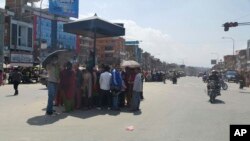 Nepalese people gather in the middle of a road during an earthquake in Bhaktapur, Nepal, Tuesday, May 12, 2015.